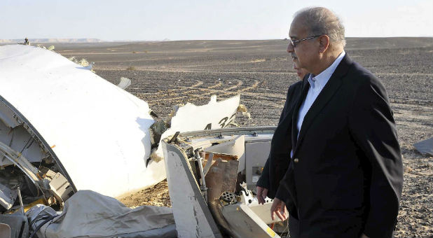 Egypt's Prime Minister Sherif Ismail looks at the remains of a plane crash in the central Sinai desert near El Arish in northern Egypt.
