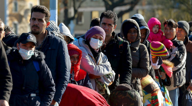 Migrants wait in line in Germany.