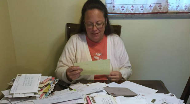 Kentucky governor orders clerks' names removed from marriage licenses at the center of a controversy involving clerk Kim Davis.