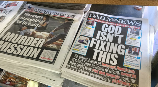 The New York Daily News front cover reads 'God Isn't Fixing This' sits on news stands in Brooklyn, New York on December 3, 2015.