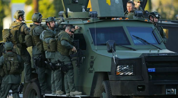 Police members search the San Bernardino area for the suspects, who were later killed.