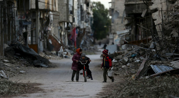 Children play amid the destruction in Syria.