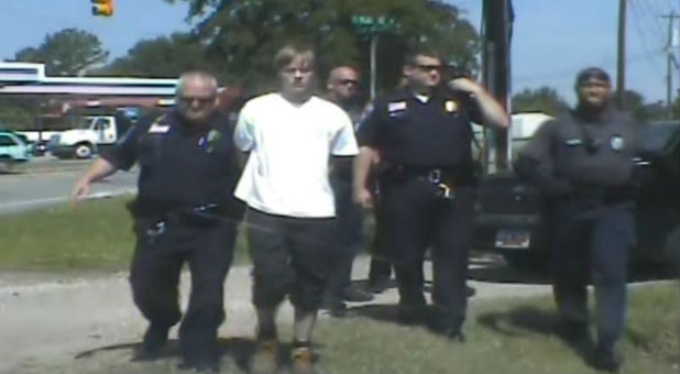 Police escort accused Charleston shooter Dylann Roof.