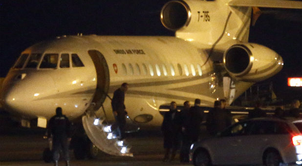 People walk off a plane carrying three Iranian-Americans, who left Tehran under a prisoner swap, after it landed at Cointrin airport in Geneva.