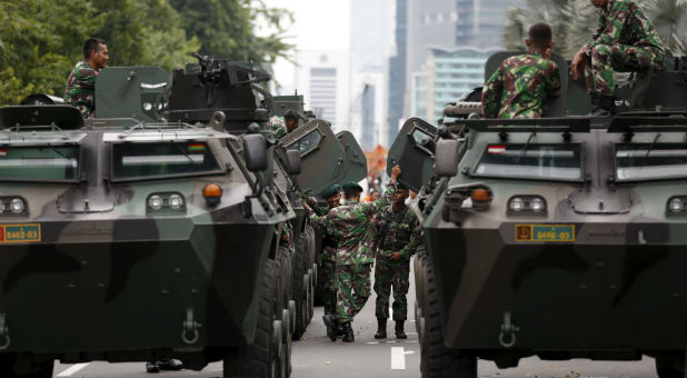Military armoured personnel carriers are seen near the site of an attack in central Jakarta.