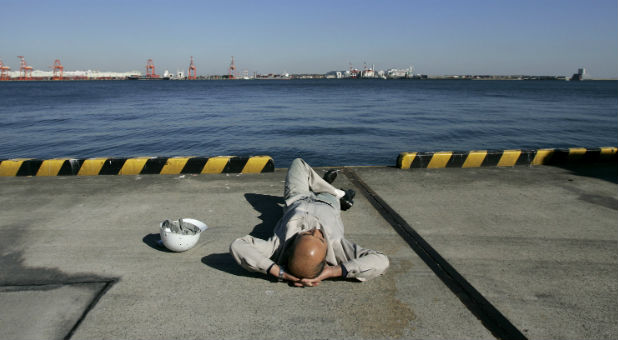 A man takes a break on a Japanese dock.