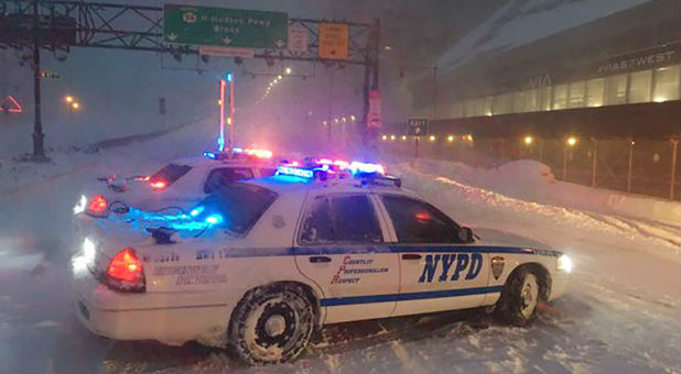 NYPD direct traffic in the Jonas storm.