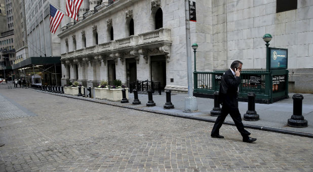 A trader walks outside the New York Stock Exchange.