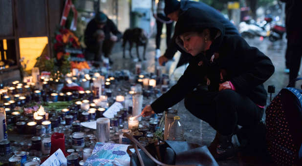 Israelis light memorial candles outside the Simta bar on Dizengoff Street in Tel Aviv on Jan. 3, 2016, two days after two Israeli Jews were killed at that bar in a shooting attack by a suspected Arab terrorist.