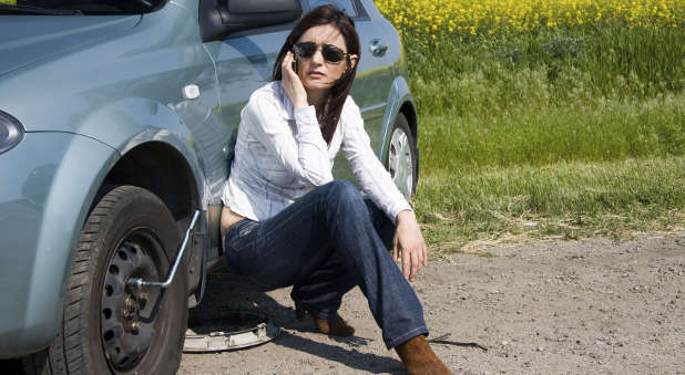 Woman changing tire
