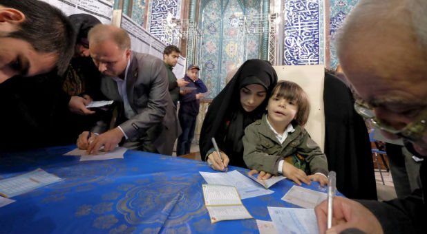 Iranians fill in their ballots during elections for the parliament and Assembly of Experts, which has the power to appoint and dismiss the supreme leader,