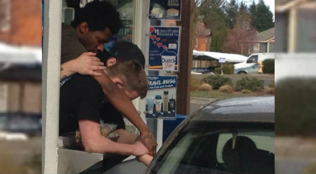 Dutch Bros Coffee employees pray for a woman in the drive-thru