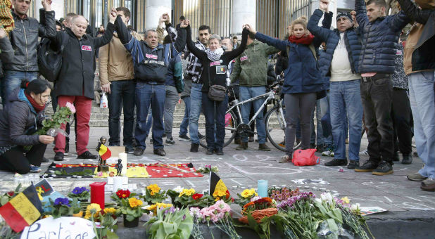 People gather around a memorial in Brussels, Belgium after twin attacks.
