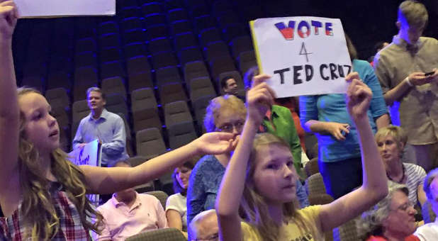 Two young ladies show their support for Sen. Ted Cruz during a rally Friday at Faith Assembly church in Orlando, Florida.