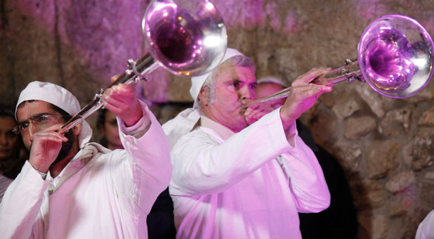 Kohanim, wearing their priestly garments, blow silver trumpets made by the Temple Institute for use in the Third Temple.