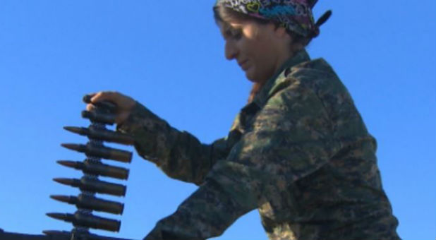 A female fighter prepares for battle with ISIS.