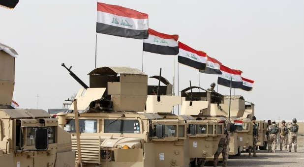 Iraqi security forces ride in vehicles travelling to Mosul to fight against militants of Islamic State.