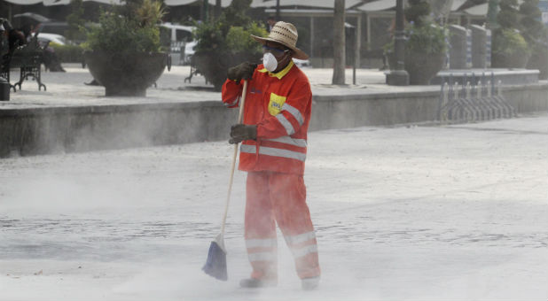 A municipal worker wears a protective mask while sweeping a floor covered with ash after an early eruption of Popocatepetl volcano in Puebla, Mexico.