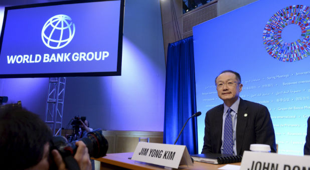 World Bank President Jim Yong Kim takes his seat as he arrives to brief the press at the opening of the IMF and World Bank's 2015 Annual Spring Meetings