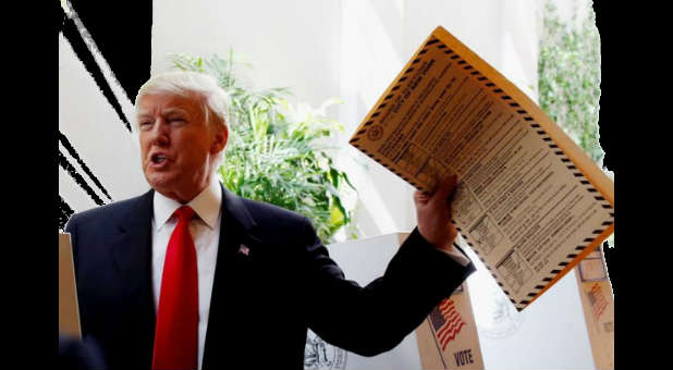 Donald Trump lifts his ballot while voting for the New York primary election in Manhattan, New York City,