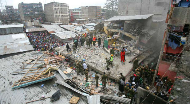 Rescue workers search the rubble of a collapsed building in Kenya for survivors.