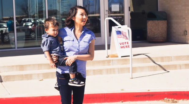 Lisa Smiley exits her polling location with her child.