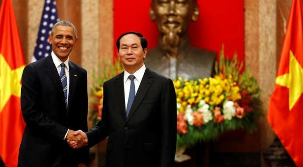 U.S. President Barack Obama shakes hands with Vietnam's President Tran Dai Quang after an arrival ceremony at the presidential palace