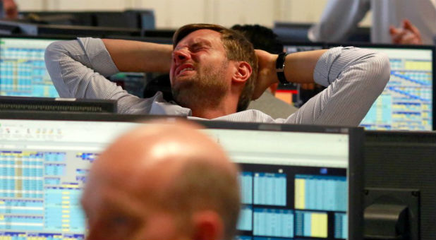 A trader from BGC, a global brokerage company in London's Canary Wharf financial centre reacts during trading June 24, 2016 after Britain voted to leave the European Union in the EU BREXIT referendum.