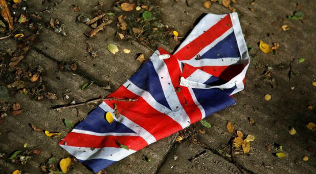 A British flag which was washed away by heavy rains the day before lies on the street in London, Britain, June 24, 2016 after Britain voted to leave the European Union in the EU BREXIT referendum.