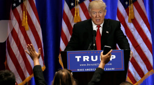 Republican presidential candidate Donald Trump is cheered as he delivers a speech at the Trump Soho Hotel in New York.