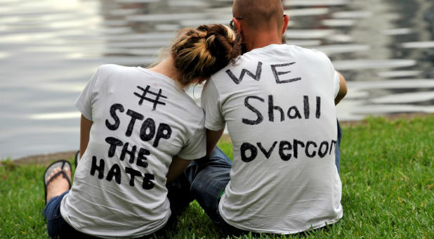 Orlando residents Arissa Suarez (L) and Malcom Crawson attend a vigil at Lake Eola Park for victims of a mass shooting at a gay nightclub in Orlando.