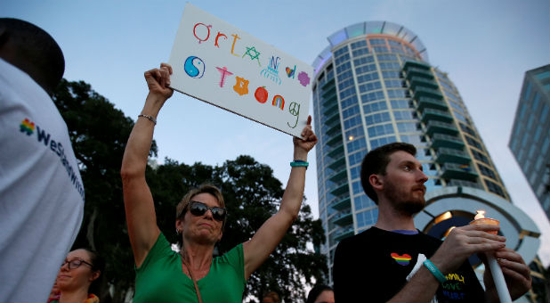 People take part in a vigil for the Pulse night club victims following last week's shooting in Orlando, Florida.