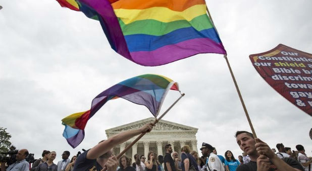 Supporters of gay marriage wave the rainbow flag after the U.S. Supreme Court ruled that the U.S. Constitution provides same-sex couples the right to marry.