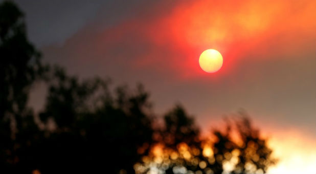 The sun is seen through smoke rising from the so-called