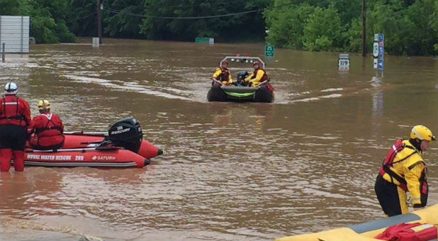 Emergency crews take out boats on a flooded I-79 at the Clendenin Exit, after the state was pummeled by up to 10 inches of rain on Thursday, causing rivers and streams to overflow into neighboring communities, in Kanawha County, West Virginia.