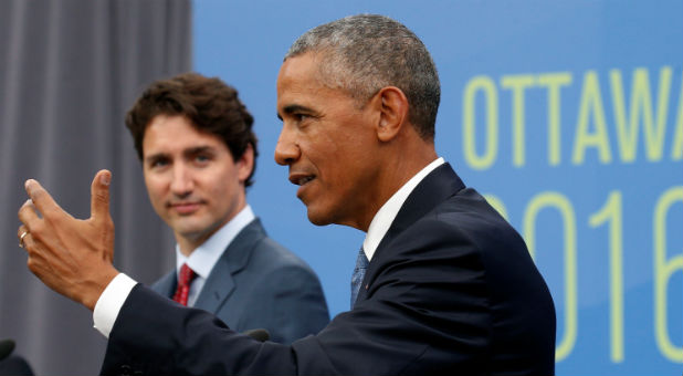 Canadian Prime Minister Justin Trudeau (L) listens as U.S. President Barack Obama speaks at a news conference during the North American Leaders' Summit.