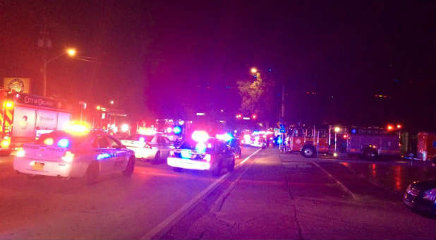 Police cars and fire trucks are seen outside the Pulse night club where police said a suspected gunman left multiple people dead and injured in Orlando, Florida.