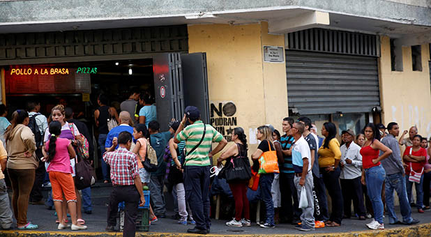 Venezuelans in line outside a store