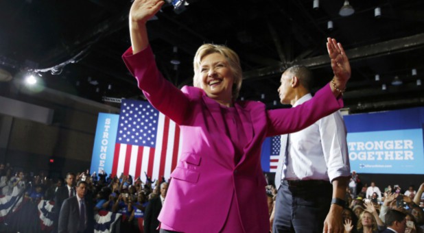 Democratic U.S. presidential candidate Hillary Clinton acknowledges supporters during a campaign rally, where she received the endorsement of U.S. President Barack Obama.