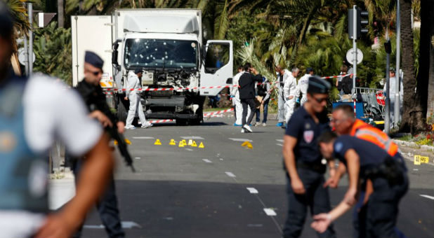 French police secure the area as the investigation continues at the scene near the heavy truck that ran into a crowd at high speed killing scores who were celebrating the Bastille Day July 14 national holiday on the Promenade des Anglais in Nice, France