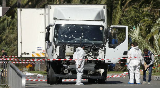 Investigators continue to work at the scene near the heavy truck that ran into a crowd at high speed killing scores who were celebrating the Bastille Day July 14 national holiday on the Promenade des Anglais in Nice, France