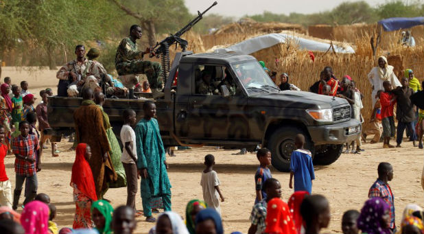 Nigerian soldiers surround refugees who fled radical Islamic violence.