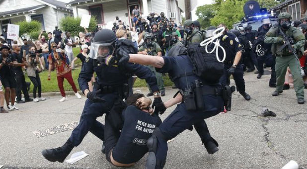 Police scuffle with a demonstrator as they try to apprehend him during a rally in Baton Rouge, Louisiana U.S.