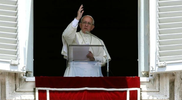 Pope Francis blesses as he leads the Angelus prayer in Saint Peter's Square at the Vatican