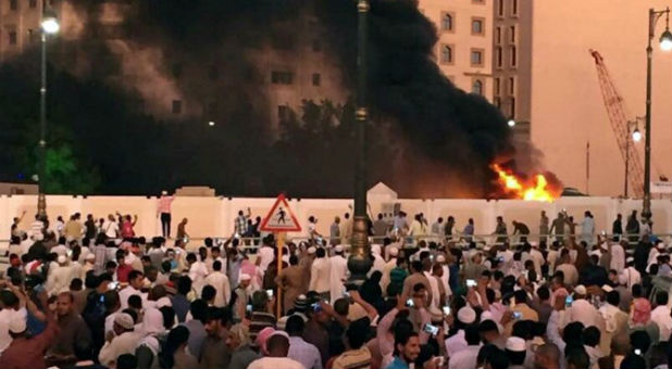 Muslims gather to pray just after a suicide bombing attack in Saudi Arabia.