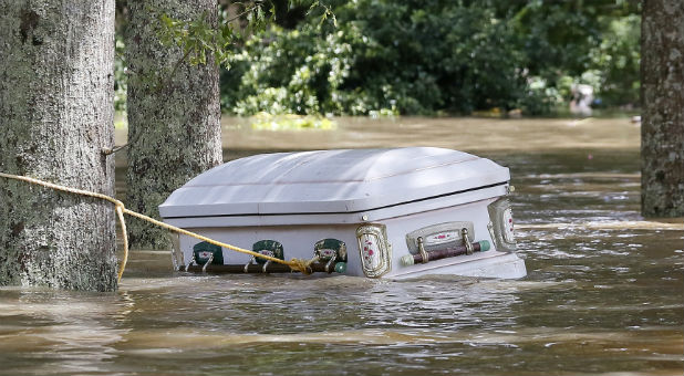 A casket is seen floating in flood waters in Ascension Parish