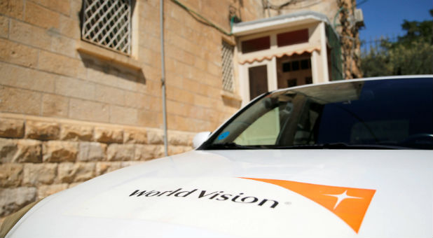 The logo of U.S.-based Christian charity World Vision is seen on a car parked outside their offices in Jerusalem.