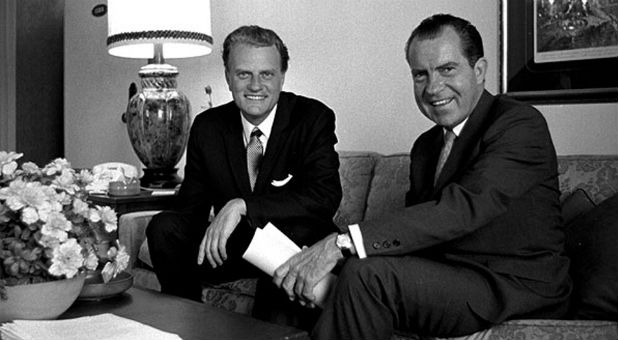 Billy Graham and President Richard Nixon smiling for the camera.