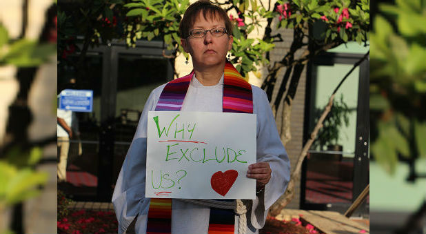 The Rev. Cynthia Meyer, a Kansas pastor who came out to her small congregation in January, joins protesters outside of the United Methodist General Conference in Portland