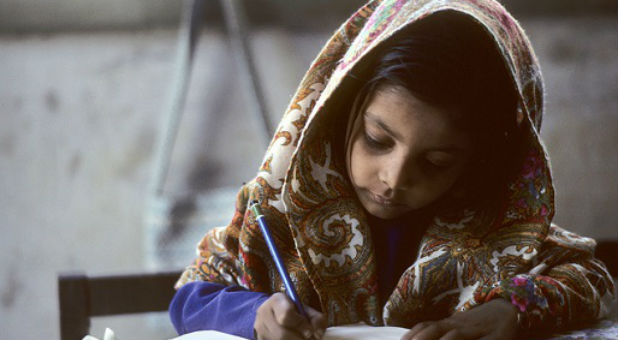 A young girl does her school work in Karachi, Pakistan, in a 2011 photo.